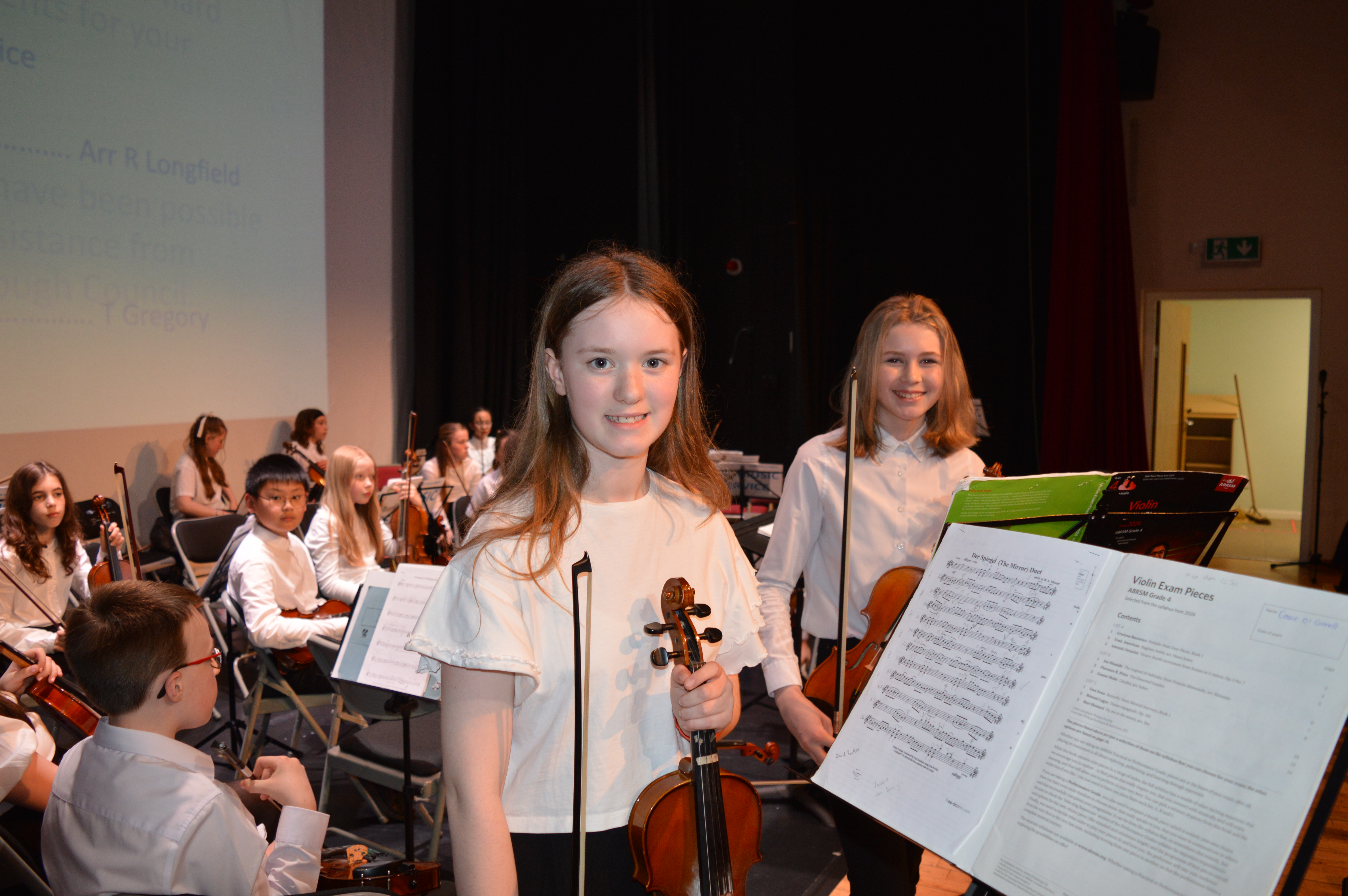Youth Orchestra musicians on stage after their concert performance 