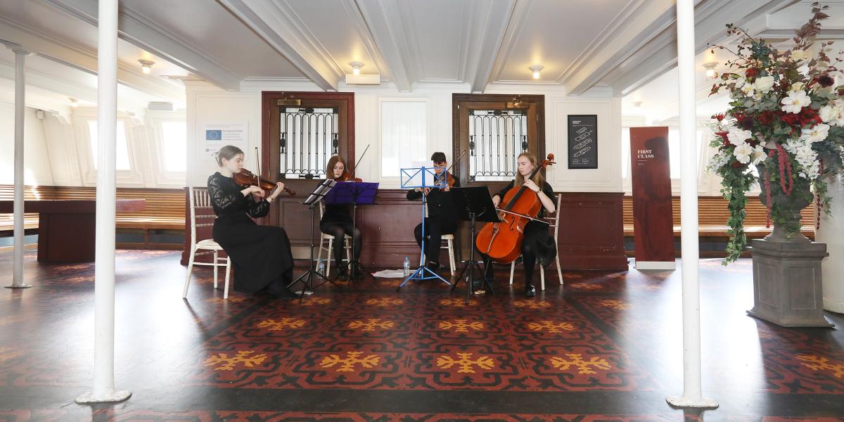 String quartet performing on board SS Nomadic