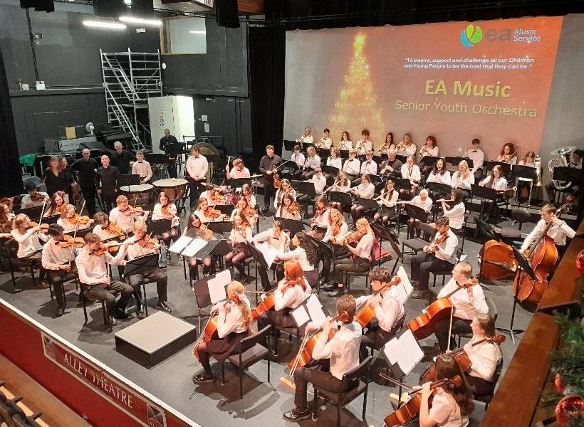 Young musicians performing in youth orchestra concert
