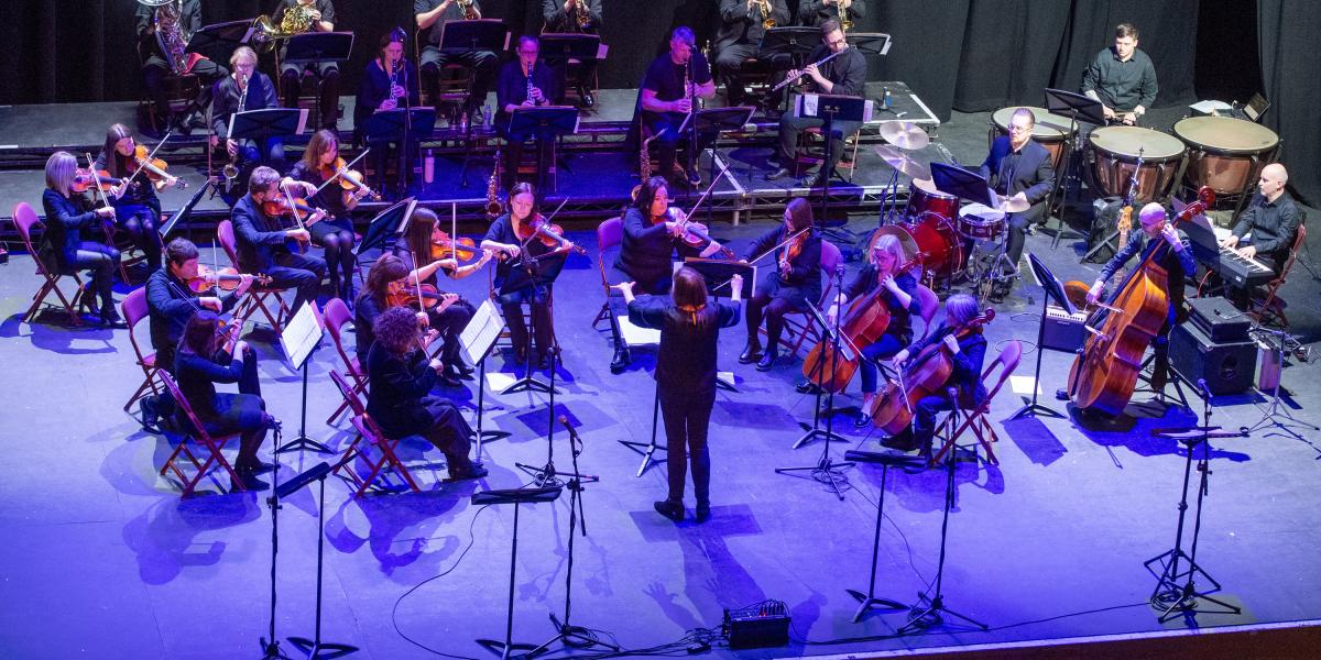 Staff orchestra on stage at Millennium Forum