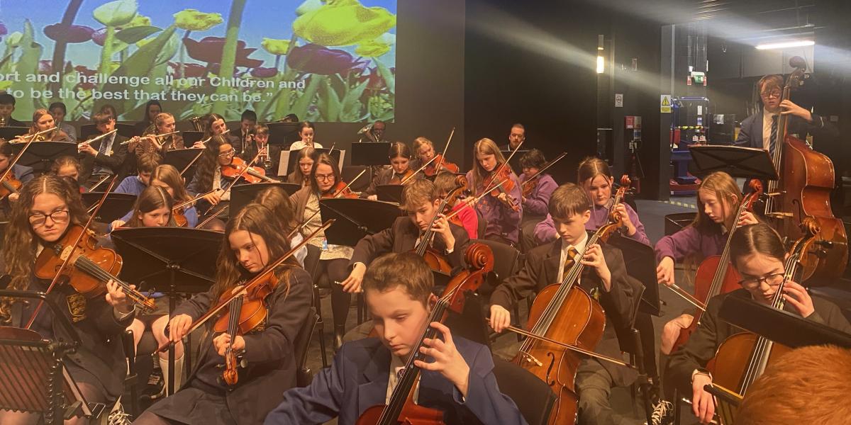 Young musicians performing in Spring concert on stage