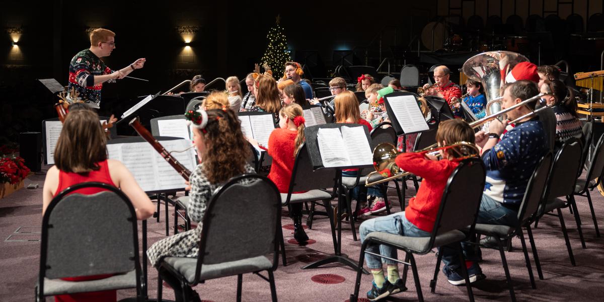Children and young people playing musical instruments at a Christmas concert.