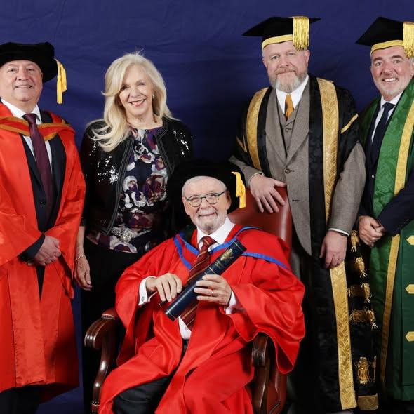Dr Sir James Galway receiving his honorary doctorate from Ulster University