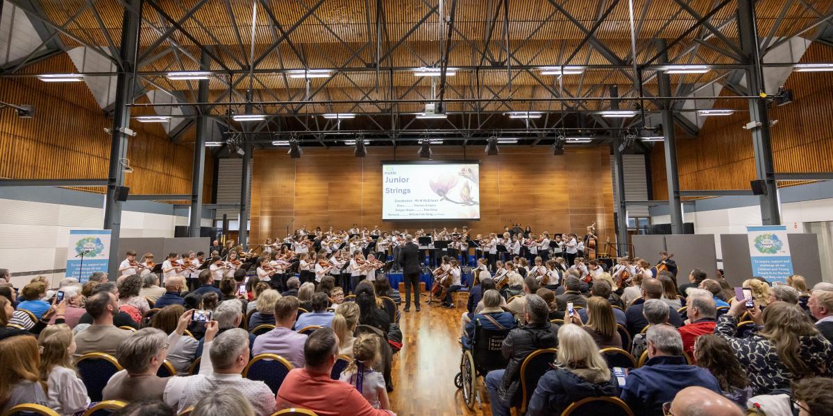 Youth orchestra performing in full hall