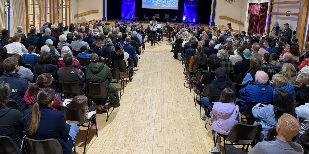 Youth orchestra performing in full hall