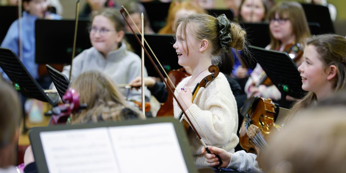 Pupils performing in an orchestra