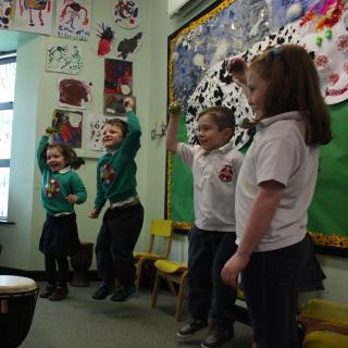 children and tutor at drumming class