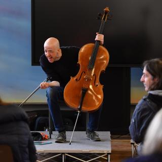 David Munn on stage with cello delivering one of the Benedetti instrumental sessions