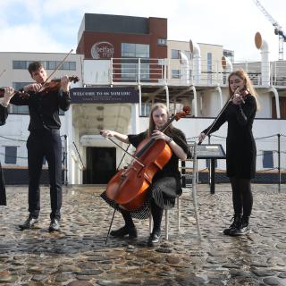 Giovani quartet in front of SS Nomadic
