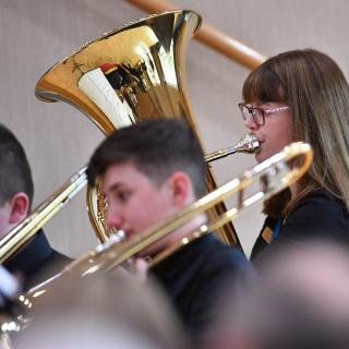 Tuba and trombones in wind band concert
