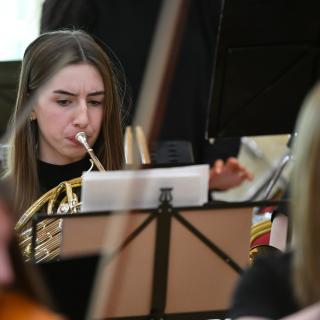 French Horn Player in youth orchestra concert