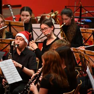 Bass clarinetist wearing santa hat in Christmas youth band concert