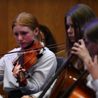 Viola player performing in youth orchestra concert