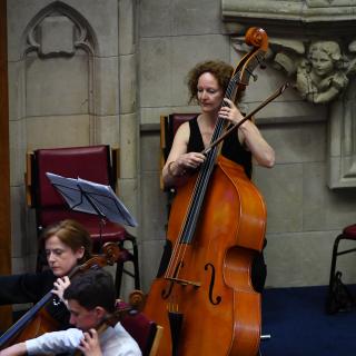 EA staff member playing Double bass in youth orchestra concert 