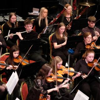 String section playing in youth orchestra concert
