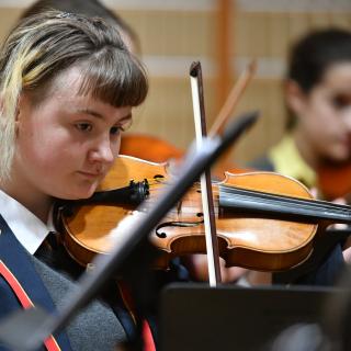 Violinist performing in orchestra concert