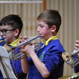 Three primary school cornet players in concert