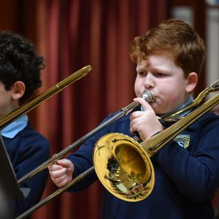 Young trombone player performing in concert