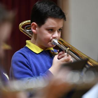 Young trombone player performing in concert
