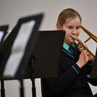 Young trombone player performing in concert