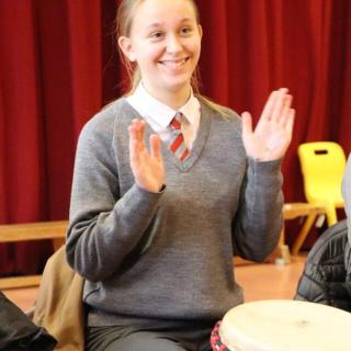 Young pupil playing African drum