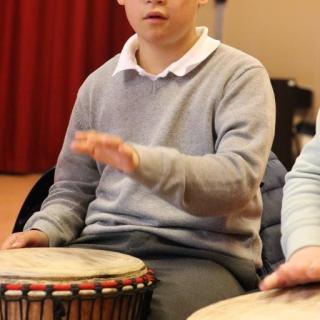 Young pupil playing African drum