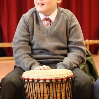 Young pupil playing African drum