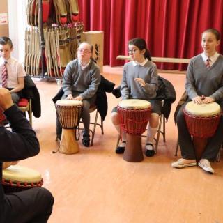 group of pupils playing in African drum workshop