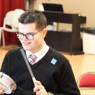 Pupil participating in percussion workshop