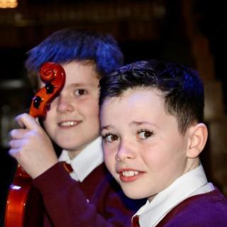 Young string players enjoying concert
