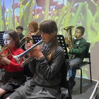Brass section performing in Strule Theatre