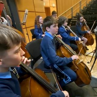Cello section performing in Strule Theatre