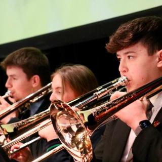 Western region Senior Youth Orchestra Trombone section performing on stage