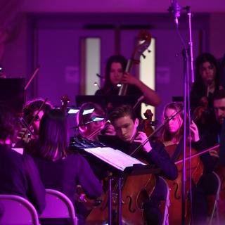 Youth Orchestra in Gala concert with purple lighting