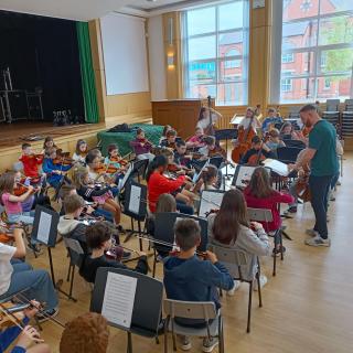 Young string players enjoying concert