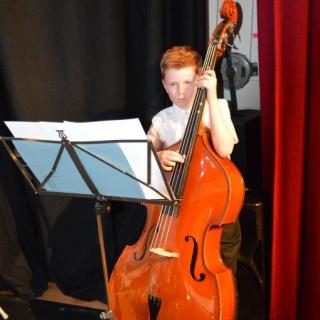 Double bass player performing in orchestra concert