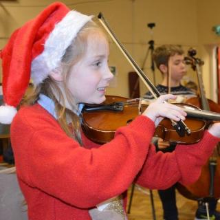 Young string players enjoying concert