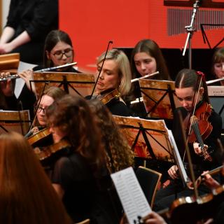 Young musicians performing in youth orchestra concert