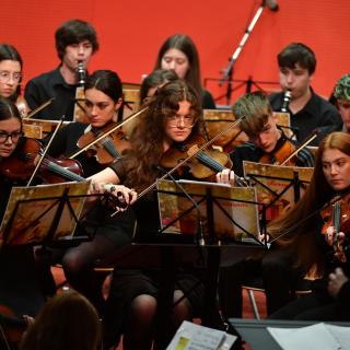 Young musicians performing in youth orchestra concert