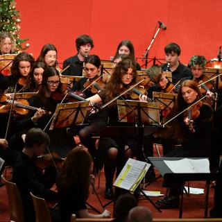 Young musicians performing in youth orchestra concert