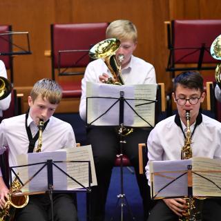 young musicians performing in wind band concert