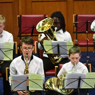 young musicians performing in wind band concert