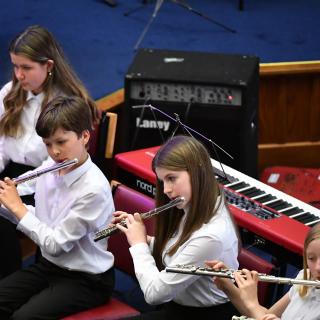 young musicians performing in wind band concert