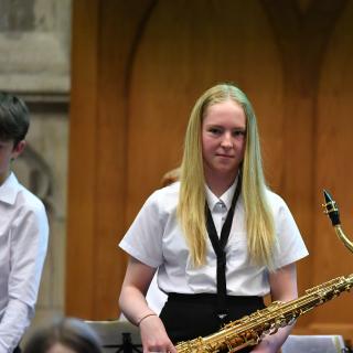 young musicians performing in wind band concert