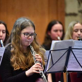 Young musicians performing in youth orchestra concert