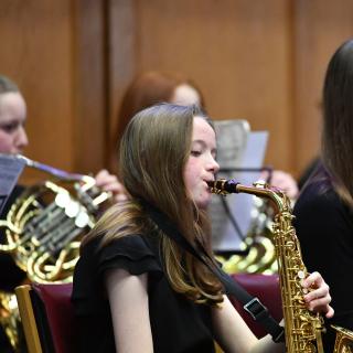 Young musicians performing in youth orchestra concert
