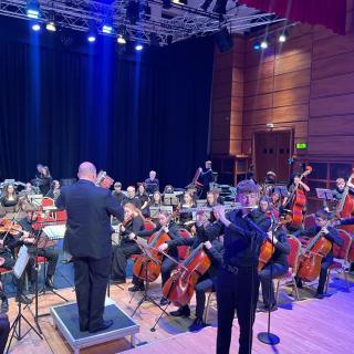 Young musicians performing in youth orchestra concert