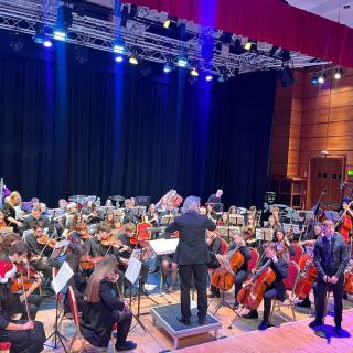 Young musicians performing in youth orchestra concert