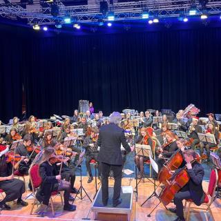 Young musicians performing in youth orchestra concert
