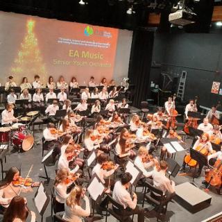 Young musicians performing in youth orchestra concert